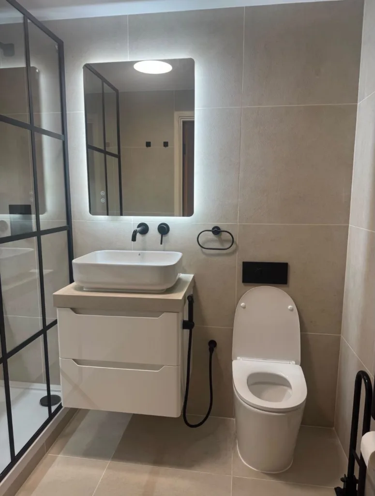 Shower room with Crittall-style screen fitted in a Kensington flat