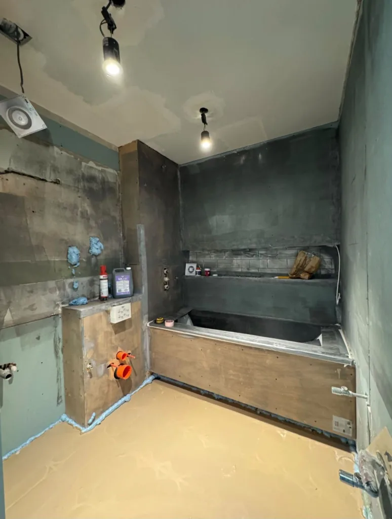 Void property mid-strip with temporary lighting and services exposed