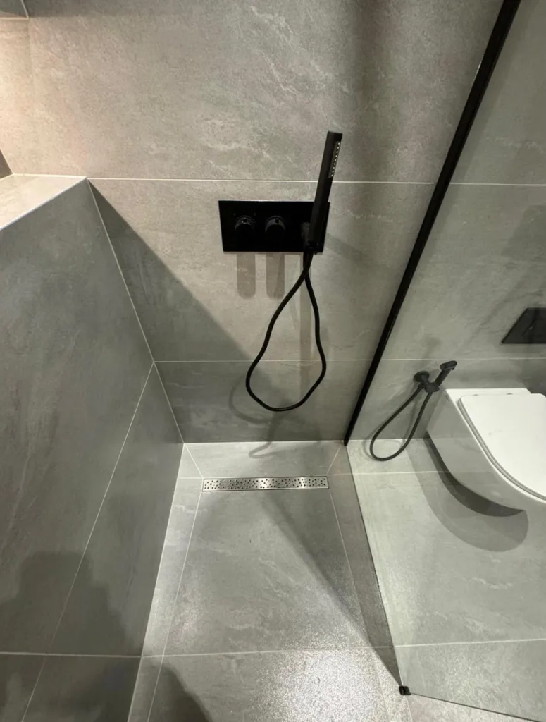 Concealed shower valve and linear drain checked on a maintenance visit